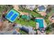 Overhead view of tennis courts and a pool and play area surrounded by well maintained greenery at 93 Ridgetree Ln, Marietta, GA 30068
