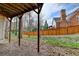 View of the backyard from under a covered deck area, showcasing the fenced yard at 93 Ridgetree Ln, Marietta, GA 30068