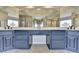 A bathroom with blue cabinets, a large mirror and granite countertops at 93 Ridgetree Ln, Marietta, GA 30068
