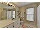 Bathroom with a large vanity, a bright window, and a combination shower-tub at 93 Ridgetree Ln, Marietta, GA 30068