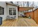 A spacious wooden deck featuring outdoor seating, dining and wooden pergola at 93 Ridgetree Ln, Marietta, GA 30068