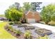View of the home's driveway featuring garden beds and an attached side-entry garage at 93 Ridgetree Ln, Marietta, GA 30068