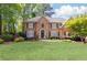 Charming brick home with a manicured lawn and mature trees, offering great curb appeal at 93 Ridgetree Ln, Marietta, GA 30068