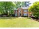 Attractive brick home with a well-manicured lawn and landscaping, creating a welcoming view at 93 Ridgetree Ln, Marietta, GA 30068