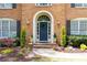 Close-up of home's entry featuring a blue door, arched entryway, and manicured landscaping at 93 Ridgetree Ln, Marietta, GA 30068