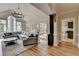 Open living room with vaulted ceilings, a chandelier, hardwood flooring, and backyard access at 93 Ridgetree Ln, Marietta, GA 30068