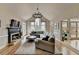 Bright living room featuring vaulted ceilings, a fireplace, and a wall of windows with backyard views at 93 Ridgetree Ln, Marietta, GA 30068