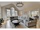 Vaulted living room with a large sectional sofa, hardwood floors, and bright natural light from large windows at 93 Ridgetree Ln, Marietta, GA 30068