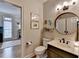 Stylish powder room with modern vanity, round mirror, and decorative wall art, perfect for guests at 93 Ridgetree Ln, Marietta, GA 30068