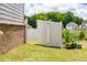 Backyard features a white fence, lush green grass, and mature trees, offering privacy and beauty at 13568 Scenic Pkwy, Covington, GA 30014
