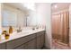 Bathroom featuring a double sink vanity with gray cabinets, gold hardware, and modern fixtures at 13568 Scenic Pkwy, Covington, GA 30014