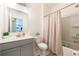 Bright bathroom featuring updated vanity, toilet, and shower with modern fixtures at 13568 Scenic Pkwy, Covington, GA 30014