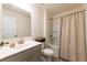 Cozy bathroom featuring a shower-tub combo, stylish vanity and a decorative mirror and lighting at 13568 Scenic Pkwy, Covington, GA 30014