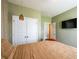Comfortable bedroom featuring a television, closet, and earth-tone colors at 13568 Scenic Pkwy, Covington, GA 30014