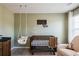 Calming Bedroom with wooden crib, swing and chair, perfect for a new baby at 13568 Scenic Pkwy, Covington, GA 30014