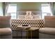 Bedroom with a checkered blanket on the bed, comfortable seating, and a neutral color scheme at 13568 Scenic Pkwy, Covington, GA 30014