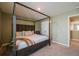 Bedroom showcasing a wooden framed bed, comfortable mattress, and easy access to laundry room at 13568 Scenic Pkwy, Covington, GA 30014