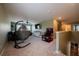 Spacious bonus room with a hanging chair, basketball game, and ceiling fan at 13568 Scenic Pkwy, Covington, GA 30014