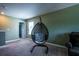 Bonus room featuring a hanging chair and a view to the hallway at 13568 Scenic Pkwy, Covington, GA 30014