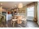 View of the kitchen and dining area with a modern table set, and stylish pendant lighting at 13568 Scenic Pkwy, Covington, GA 30014