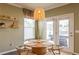 Cozy dining area with stylish lighting, neutral decor, and access to a patio or backyard at 13568 Scenic Pkwy, Covington, GA 30014