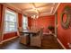 Elegant dining room featuring tray ceilings, a modern chandelier, and vibrant red walls at 13568 Scenic Pkwy, Covington, GA 30014