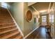 Inviting entryway showcasing a staircase, hardwood floors, and stylish wall decor at 13568 Scenic Pkwy, Covington, GA 30014