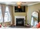Modern living room with a sleek fireplace, large windows, and comfortable seating at 13568 Scenic Pkwy, Covington, GA 30014