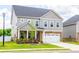 Charming two-story home features brick and gray siding, a two-car garage, and a well-manicured lawn at 13568 Scenic Pkwy, Covington, GA 30014