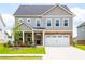 Charming two-story home features brick and gray siding, a two-car garage, and a well-manicured lawn at 13568 Scenic Pkwy, Covington, GA 30014