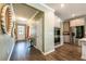 Hallway view with an entrance door, neutral paint, white cabinets, and stainless steel appliances at 13568 Scenic Pkwy, Covington, GA 30014