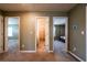 Hallway with open doorways to bedrooms and bathroom, showcasing the home's layout at 13568 Scenic Pkwy, Covington, GA 30014