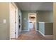 Open hallway with neutral paint, carpet and doors to the laundry room and other rooms at 13568 Scenic Pkwy, Covington, GA 30014
