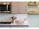 Close up of the kitchen showing granite countertops, stainless appliances, and cabinets with decorative hardware at 13568 Scenic Pkwy, Covington, GA 30014