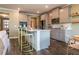 Kitchen with stainless steel appliances, grey cabinets, an island, and hardwood floors at 13568 Scenic Pkwy, Covington, GA 30014