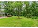 Spacious backyard featuring a gazebo, mature trees, and a lush lawn, perfect for outdoor enjoyment at 211 Caboose Ln, Woodstock, GA 30189