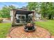 Backyard featuring a gazebo with outdoor furniture and a fire pit with chairs at 211 Caboose Ln, Woodstock, GA 30189