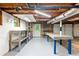 Unfinished basement area with white walls, exposed ceiling, shelving and an access door at 211 Caboose Ln, Woodstock, GA 30189