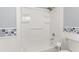 Bathroom with blue and white tile, and a shower/tub combo at 211 Caboose Ln, Woodstock, GA 30189