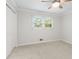 Neutral bedroom with a ceiling fan and large window with white trim at 211 Caboose Ln, Woodstock, GA 30189