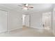 Spacious bedroom with neutral walls, a ceiling fan, and access to an ensuite bathroom at 211 Caboose Ln, Woodstock, GA 30189