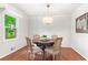 Charming dining area with hardwood floors, natural light, and wainscoting at 211 Caboose Ln, Woodstock, GA 30189