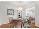 Cozy dining room with hardwood floors and stylish lighting fixture at 211 Caboose Ln, Woodstock, GA 30189