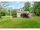 Exterior view of the home showcasing a beautiful backyard with a gazebo and lush landscaping at 211 Caboose Ln, Woodstock, GA 30189