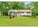 Charming single-story home with a well-manicured front yard and cozy porch at 211 Caboose Ln, Woodstock, GA 30189