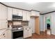 Modern kitchen equipped with stainless steel appliances and ample cabinet space at 211 Caboose Ln, Woodstock, GA 30189