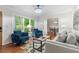 Bright living room with comfortable seating and views of the landscaped yard at 211 Caboose Ln, Woodstock, GA 30189