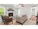 Bright living room with a white brick fireplace, neutral furnishings, and a ceiling fan at 211 Caboose Ln, Woodstock, GA 30189