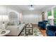 Comfortable living room with hardwood floors, a gray sofa, blue armchairs, and natural light at 211 Caboose Ln, Woodstock, GA 30189