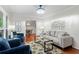 Cozy living room featuring hardwood floors, a gray sofa, blue armchairs, and a floral rug at 211 Caboose Ln, Woodstock, GA 30189